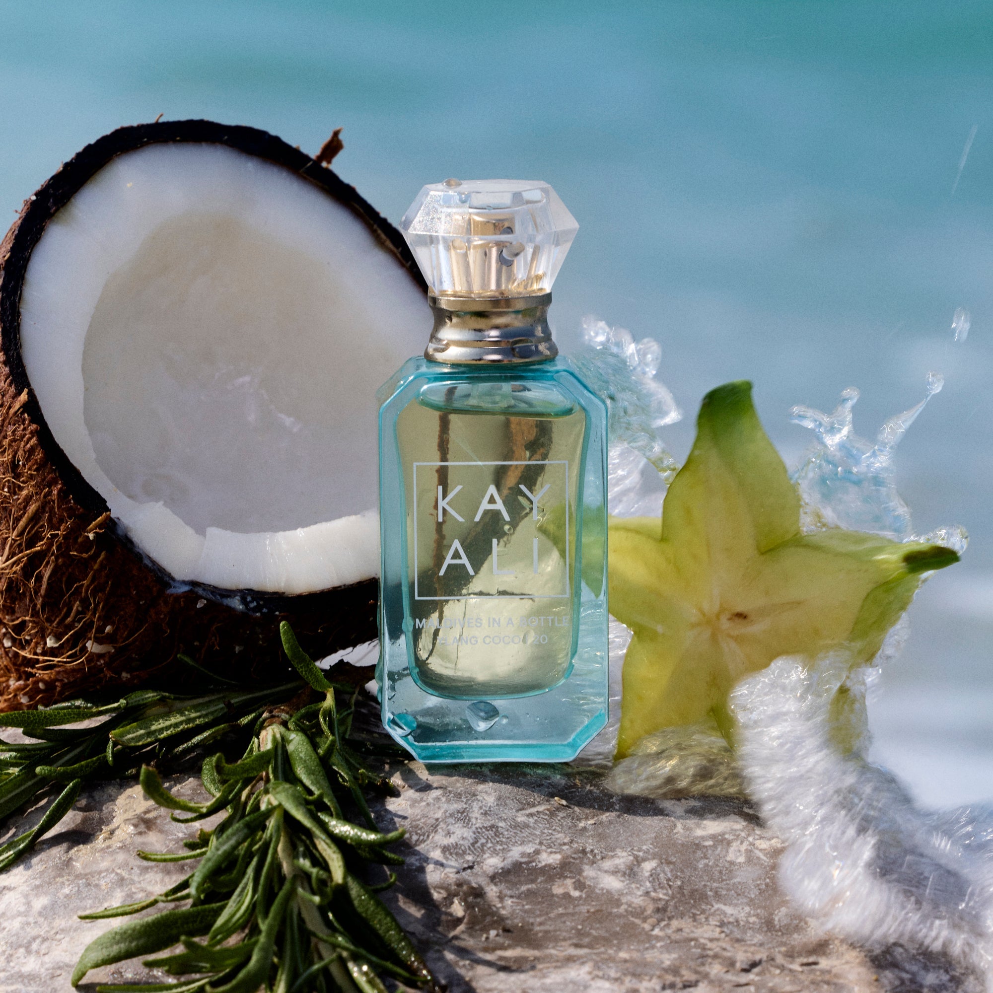 Perfume bottle with a star fruit and coconut on a beach setting